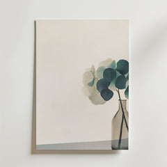 En minimalistisk målning av en glasvas med eukalyptusgrenar på en slät yta och ljus bakgrund, tryckt som Bozetto Hydrangea Haven Poster på FSC-certifierat premiumpapper med en lyxig matt finish.