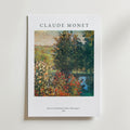 Bozetto Claude Monet Garden At Montregon Poster föreställer livfulla blommor, frodiga träd och en blå damm från Monets målning från 1876. Postern är tryckt på premiumpapper och visar Monets namn på ett elegant sätt högst upp.
