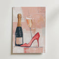Bozetto Champagne & Couture Poster visar en målning av en champagneflaska, ett glas och en röd högklackad sko på en rosa-beige abstrakt bakgrund, tryckt på lyxigt matt premiumpapper för en elegant finish.