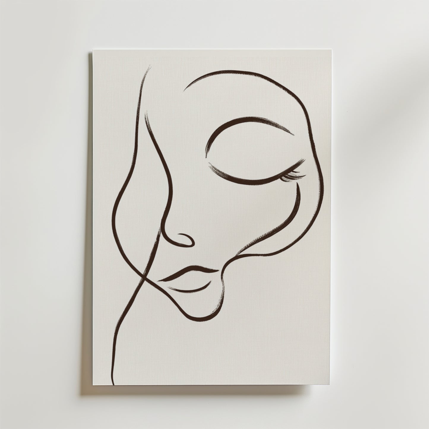 Dreamy Line Art Face Poster" av Bozetto föreställer ett lugnt ansikte med slutna ögon och böjda läppar, tecknat med minimalistiska svarta linjer på vit canvas för en elegant, abstrakt look.