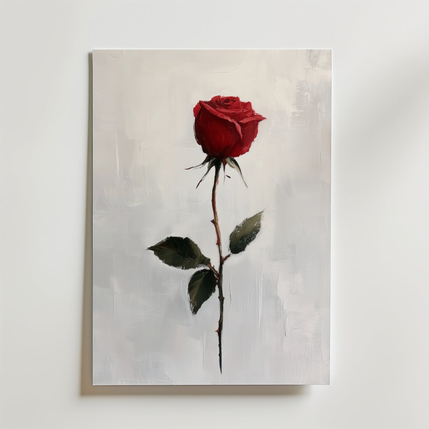 Bozetto Red Rose Poster visar en enda röd ros med gröna blad på premiumpapper mot en vit texturerad bakgrund och skapar en elegant väggkonst för ditt rum.