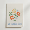 Bozetto Floral väggkonst garden green Poster föreställer minimala orange och gula blommor med gröna blad och "LE JARDIN RÊVE" i blått på en vit bakgrund, tryckt på FSC-certifierat premiumpapper.