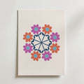 Bozetto Geometric Floral Mandala Poster visar röda och lila tecknade blommor i ett cirkulärt mönster runt en marinblå mandala på en ljus bakgrund - perfekt för dig som gillar färgglad fotokonst.