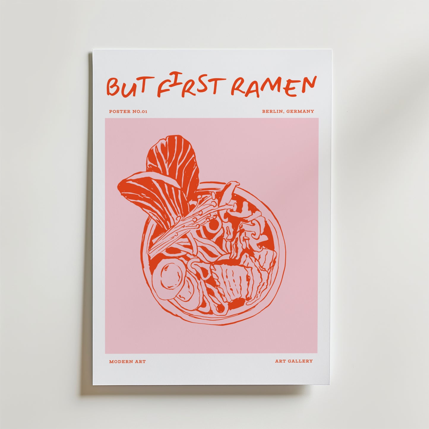 The First Ramen Poster by Bozetto visar "BUT FIRST RAMEN" med en orange och vit nudelskål på rosa, märkt "Poster No.01", "Berlin, Germany" och "Modern Art" - perfekt för matkonstfans eller snygg köksinredning.
